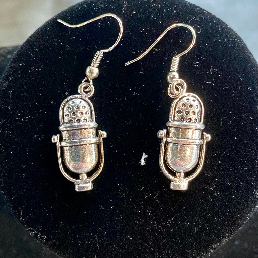 Silver microphone earrings.